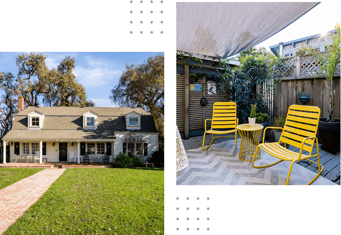 A house with two chairs and a table in the yard.