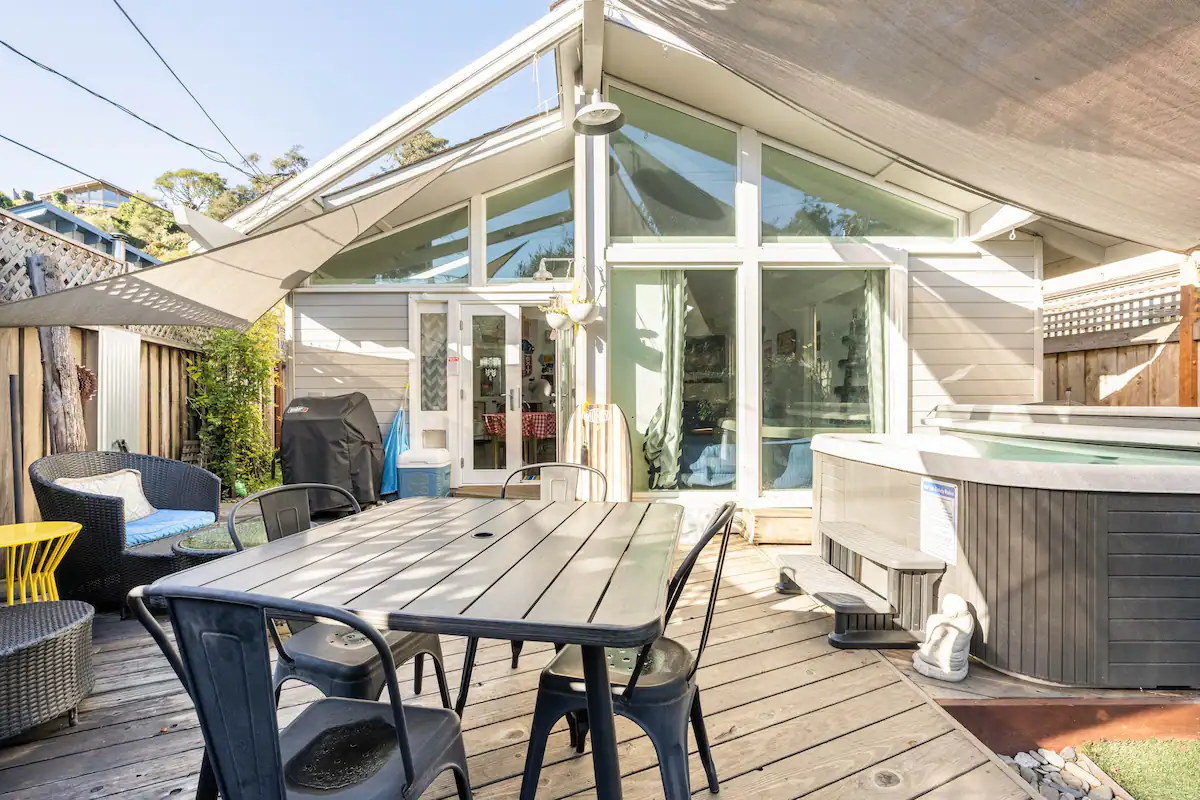 A patio with a table and chairs on top of it.