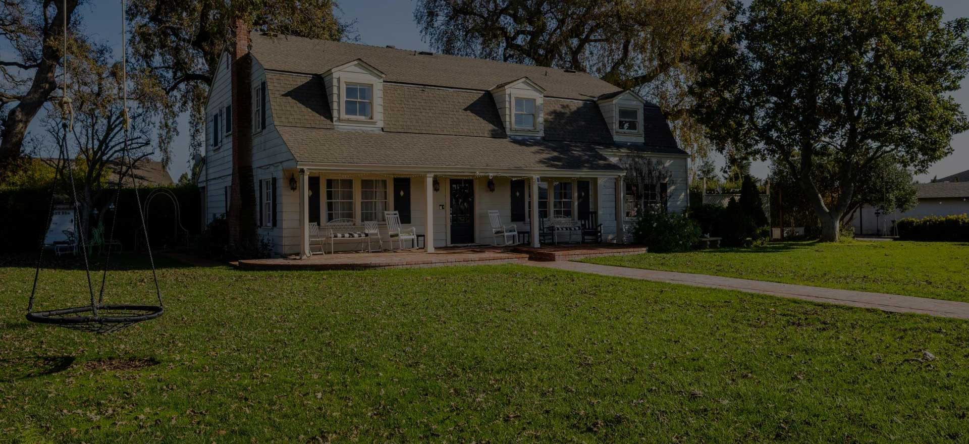 A large house with a lawn in front of it.