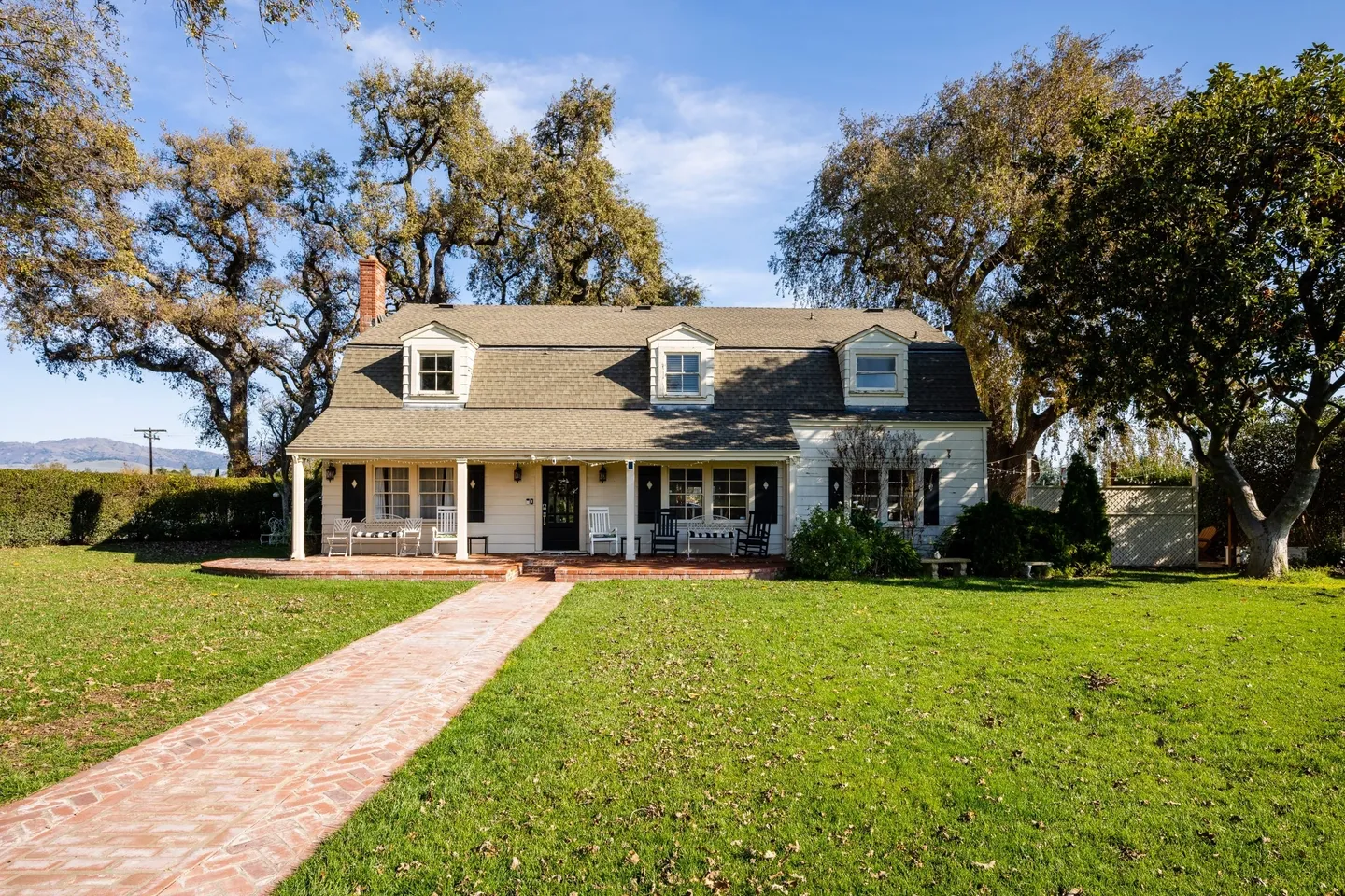 A house with a brick walkway in front of it.