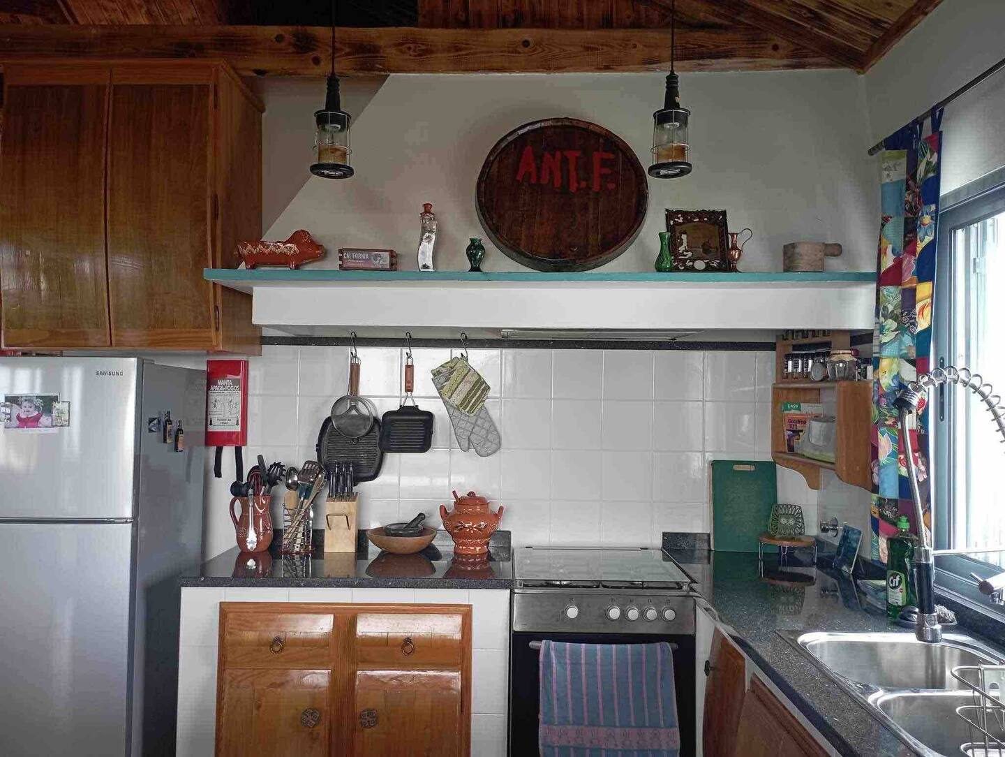 A kitchen with an oven and sink in it