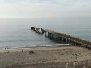 A pier with a boat on it in the middle of the ocean.