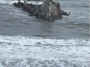 A boat is in the water near shore.