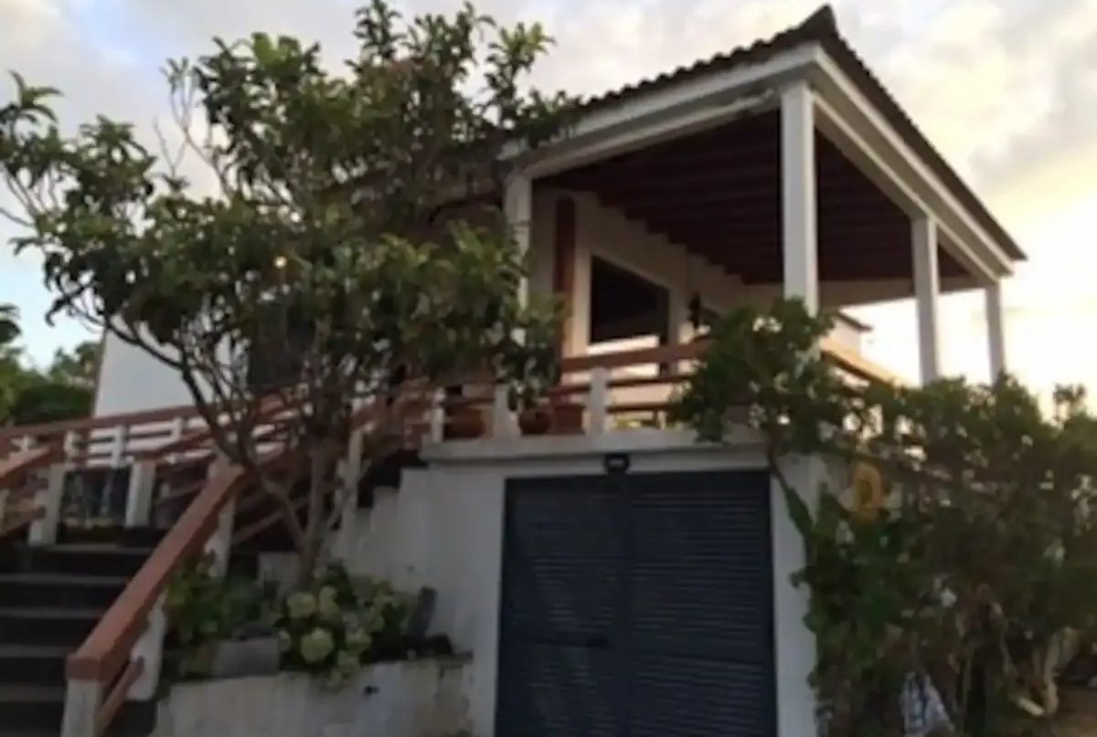 A house with a garage and balcony in it