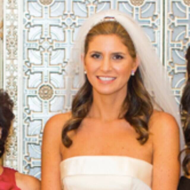 A bride and her two bridesmaids posing for the camera.