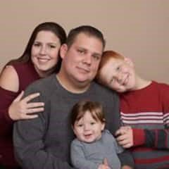 A family posing for a picture in their home.