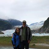 A man and woman standing in front of a mountain.